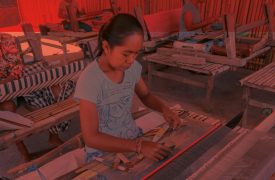 woman weaving by hand